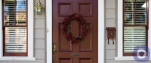 Front door to a home with a wreath decoration